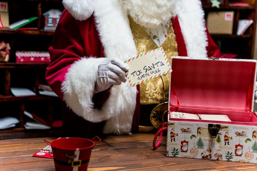 Santa pulling a letter from his mailbox